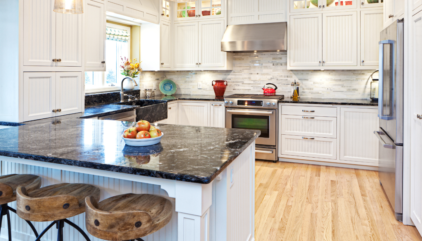 A large kitchen with a center island with stools