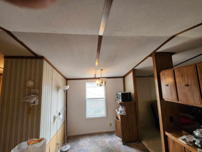 A room that has a ceiling fan in it