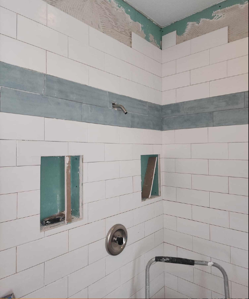 A bathroom that has been painted white and has a hole in the wall