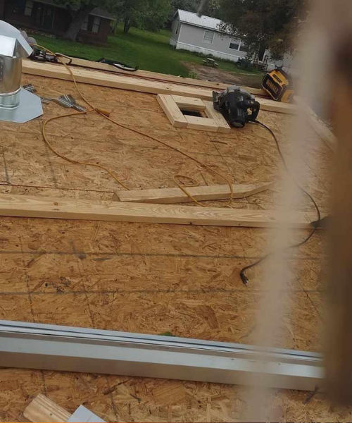 A view from a window of a roof being built