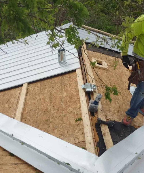 A man standing on top of a roof